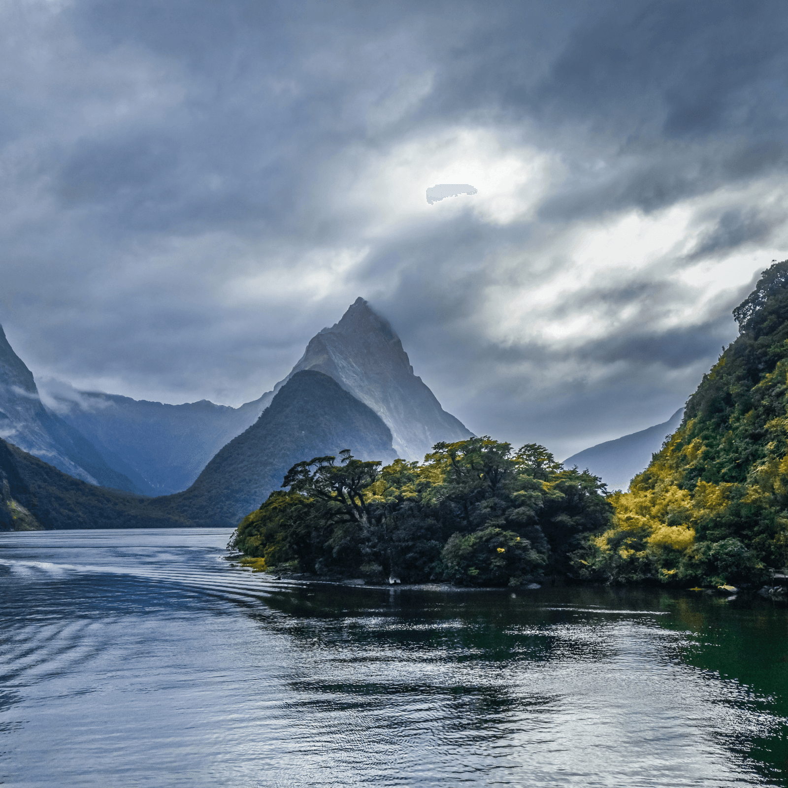 Milford Sound Cruise: Sail through towering cliffs, serene waters, and cascading waterfalls.