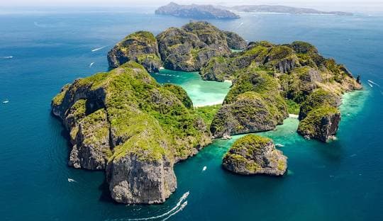 Phi Phi Island Excursion: Snorkel in crystal-clear waters and relax on pristine beaches surrounded by stunning limestone cliffs.